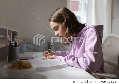 Smart teen girl study with textbook at home 70613434