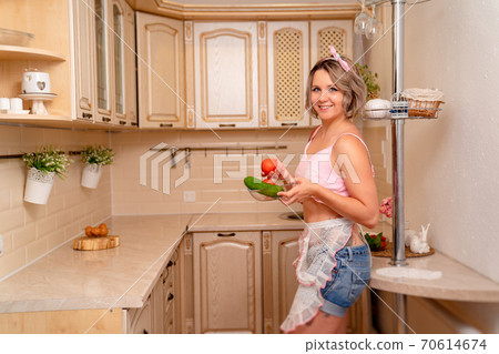 sexy blonde housewife with tomatoes and cucumbers sexy blonde housewife with tomatoes and cucumbers 70614674