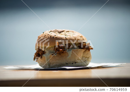 Closeup of pork burger on the table of the restaurant terrace 70614959