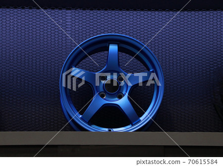 Blue Alloy Wheel of car on the shelf. Alloy wheels are wheels that are made from an aluminium Blue Alloy Wheel of car on the shelf. Alloy wheels are wheels that are made from an aluminium 70615584