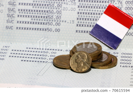 Heap of French franc coin money and mini France flag on the book bank. Concept of Saving money. 70615594