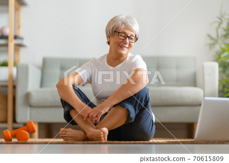 Senior woman exercising at home. 70615809