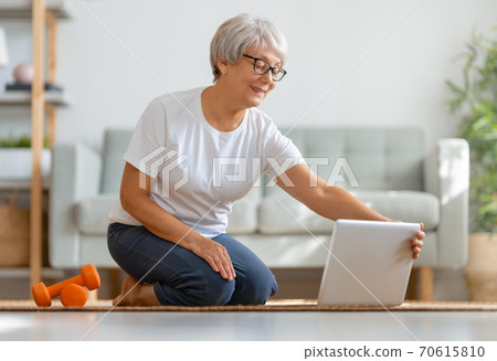 Senior woman exercising at home. 70615810