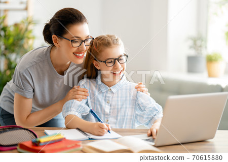 Girl doing homework or online education. 70615880