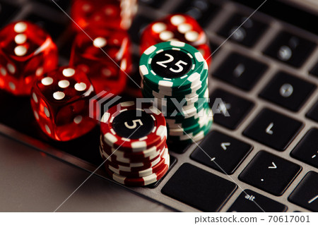 Online casino concept. Gambling chips and five red dices close-up Online casino concept. Gambling chips and five red dices close-up 70617001