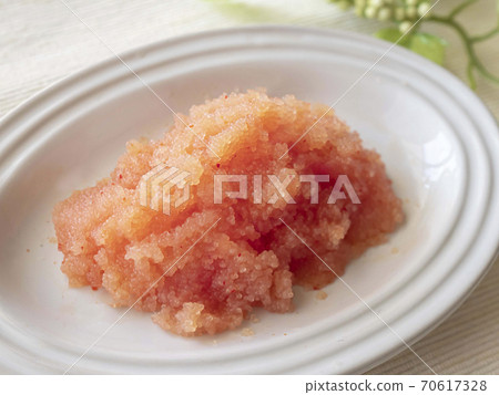 Loosened spicy cod roe served on a white plate for raw consumption Loosened spicy cod roe served on a white plate for raw consumption 70617328