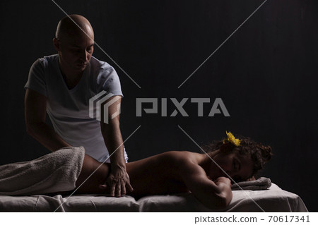 bald masseur doing massage bald masseur doing massage 70617341