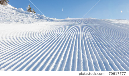 Close-up straight line rows of ski slope piste 70617777