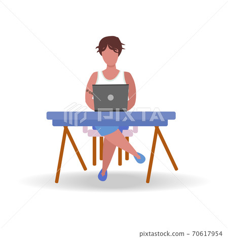 A man works at a laptop at home at a table. Freelance concept, quarantine due to covid-19 A man works at a laptop at home at a table. Freelance concept, quarantine due to covid-19 70617954