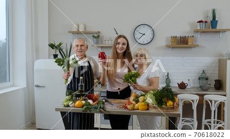 Girl with mature man and woman recommending eating raw vegetable food. Healthy nutrition diet Girl with mature man and woman recommending eating raw vegetable food. Healthy nutrition diet 70618022