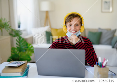 Schoolboy learning online indoors at home, coronavirus concept. 70620149
