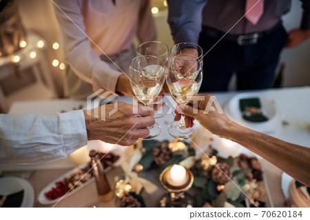 Unrecognizable multi-generation family indoors celebrating Christmas together. Unrecognizable multi-generation family indoors celebrating Christmas together. 70620184