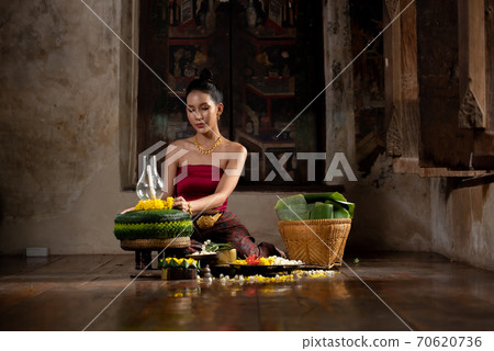Thai girl in traditional dress costume making and decorating Krathong. Loy Krathong Festival. Thai girl in traditional dress costume making and decorating Krathong. Loy Krathong Festival. 70620736