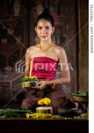 Thai girl in traditional dress costume making and decorating Krathong. Loy Krathong Festival. Thai girl in traditional dress costume making and decorating Krathong. Loy Krathong Festival. 70620742