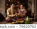 Thai couple in traditional dress costume making and decorating Krathong. Loy Krathong Festival. 70620762