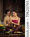 Thai couple in traditional dress costume making and decorating Krathong. Loy Krathong Festival. 70620765