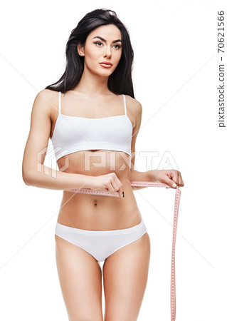 Slim tanned woman's body isolated on white background - waist measurement 70621566