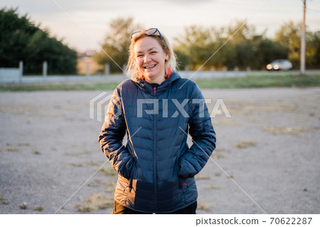 Caucasian woman outdoors traveling in cold weather alone. Vertical portrait candid photo Caucasian woman outdoors traveling in cold weather alone. Vertical portrait candid photo 70622287