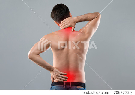 Man holding his hands behind his back 70622730