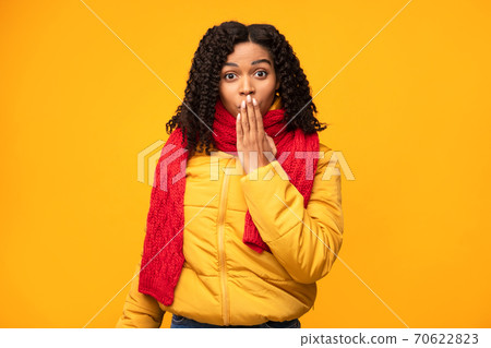 African Woman Covering Mouth Posing Standing Over Yellow Studio Background African Woman Covering Mouth Posing Standing Over Yellow Studio Background 70622823
