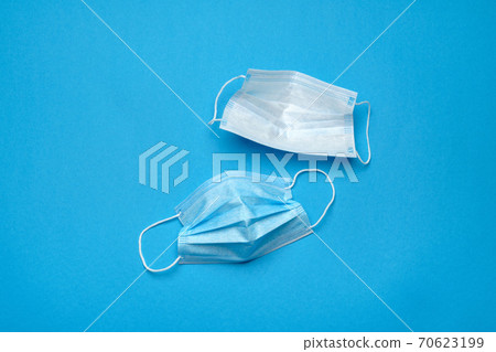 Disposable blue medical face masks on blue background 70623199