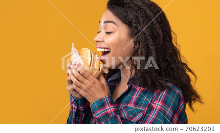 Funny African American Lady Eating Burger At Studio 70623201