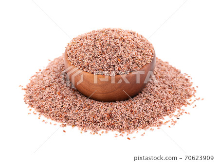 Plantago ovata seeds, isolated on white background. Plantain, indian flea or psyllium seeds in wooden bowl. 70623909