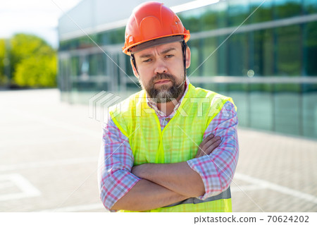 foreman in vest and protective helmet foreman in vest and protective helmet 70624202