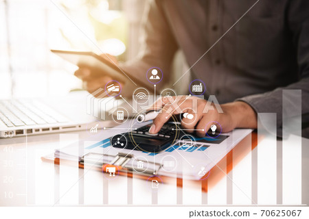accountant working on laptop computer with business document, graph diagram and calculator on office table in office. 70625067