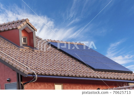Eco-house Western-style roof, solar panels and blue sky 70625713