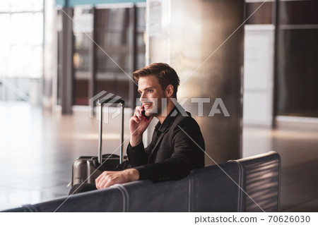 Man talking on the phone i the airport Man talking on the phone i the airport 70626030
