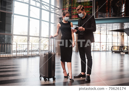 Man and woman checking their boarding passes 70626174