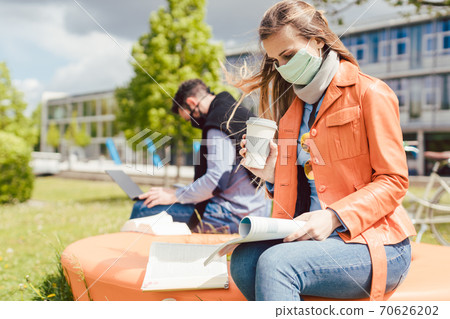 Woman student on college campus learning wearing face mask Woman student on college campus learning wearing face mask 70626202