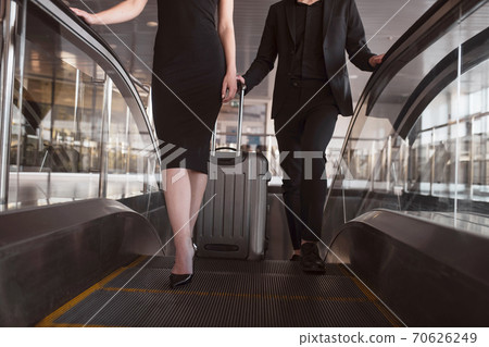 Man and woman wearing black clothes preparing for the flight Man and woman wearing black clothes preparing for the flight 70626249