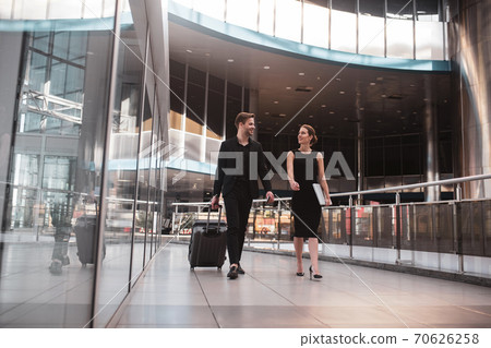 Man and woman arriving at the airport for the business trip Man and woman arriving at the airport for the business trip 70626258