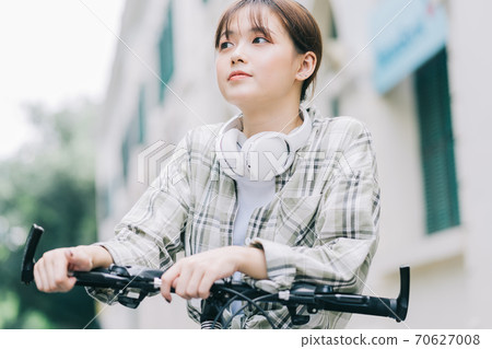 woman cycling on the street woman cycling on the street 70627008
