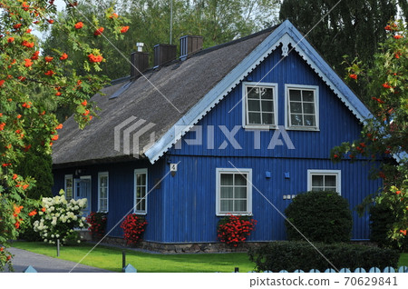 old old wooden house, red, in the European country of Lithuania, in the spa town of Nida, on the Curonian Spit. 70629841