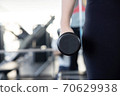 Close-Up on Woman Hand Holding Dumbell 70629938