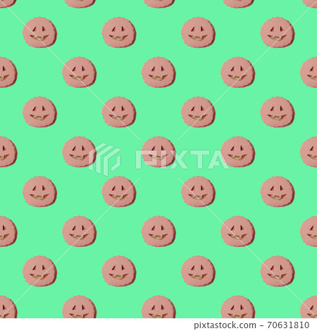 repeating pattern of sausage sandwiches with cut-out faces. A Halloween-style treat. Top view on a green background repeating pattern of sausage sandwiches with cut-out faces. A Halloween-style treat. Top view on a green background 70631810