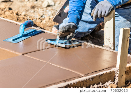 Construction Worker Using Hand Groover On Wet Cement Forming Coping Around New Pool Construction Worker Using Hand Groover On Wet Cement Forming Coping Around New Pool 70632013