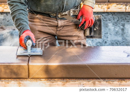 Construction Worker Using Hand Groover On Wet Cement Forming Coping Around New Pool Construction Worker Using Hand Groover On Wet Cement Forming Coping Around New Pool 70632017
