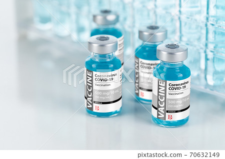 Coronavirus COVID-19 Vaccine Vials Near Test Tubes On Reflective Surface Coronavirus COVID-19 Vaccine Vials Near Test Tubes On Reflective Surface 70632149