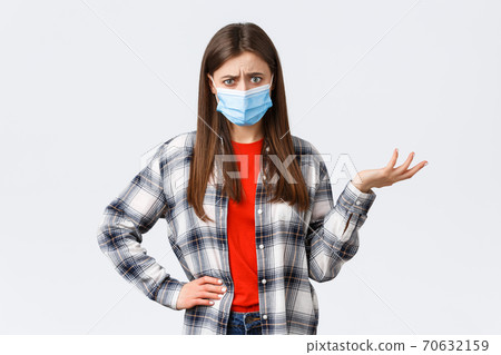 Coronavirus outbreak, leisure on quarantine, social distancing and emotions concept. Confused and bothered young woman cant understand this, shrug and stare puzzled camera, medical mask Coronavirus outbreak, leisure on quarantine, social distancing and emotions concept. Confused and bothered young woman cant understand this, shrug and stare puzzled camera, medical mask 70632159