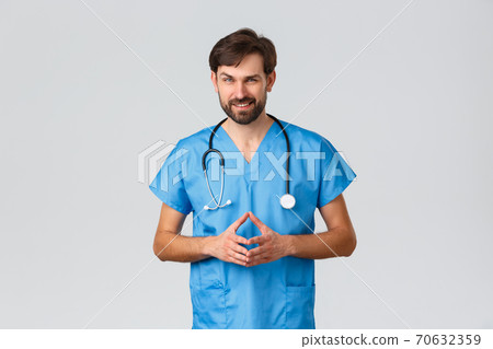 Healthcare workers, coronavirus quarantine campaign and pandemic concept. Thoughtful, genius doctor or nurse in blue scrubs and stethoscope, look sly or scheming, having excellent plan fight disease Healthcare workers, coronavirus quarantine campaign and pandemic concept. Thoughtful, genius doctor or nurse in blue scrubs and stethoscope, look sly or scheming, having excellent plan fight disease 70632359