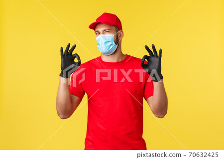 Express delivery during pandemic, covid-19, safe shipping, online shopping concept. Courier ensure and promise best and fast package, order delivery, wink and camera show okay sign Express delivery during pandemic, covid-19, safe shipping, online shopping concept. Courier ensure and promise best and fast package, order delivery, wink and camera show okay sign 70632425