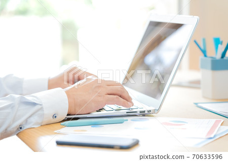 Hands of a man teleworking 70633596