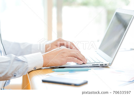 Hands of a man teleworking Hands of a man teleworking 70633597
