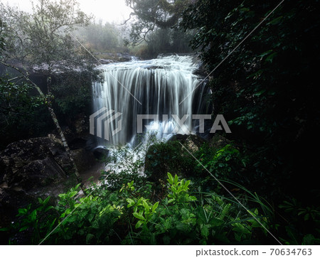 Pen Pob Mai Waterfall at Phu Kradueng National Park, Loei, Thailand. Landscape of waterfall in forest of Thailand during wet season. 70634763
