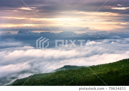 Sea of fog and sunrise landscape in morning with faraway mountain. 70634831