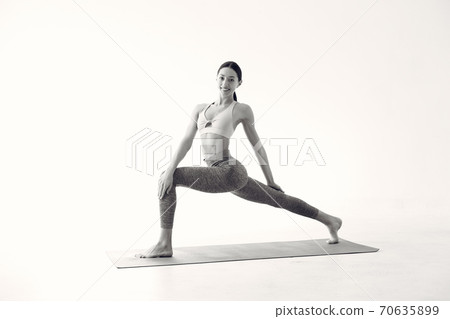 A beautiful girl is engaged in a yoga studio A beautiful girl is engaged in a yoga studio 70635899